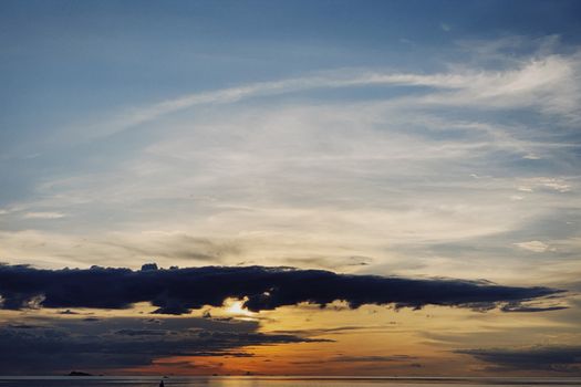 A breathtaking sunset over the sea with dramatic clouds and vivid sky colors.