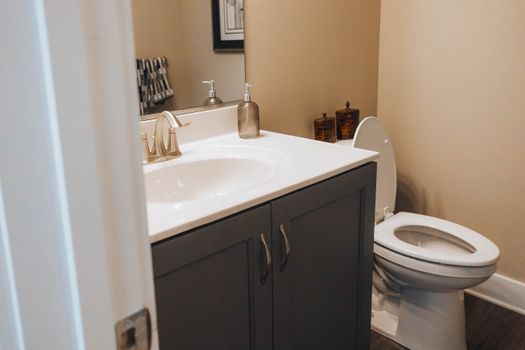 A clean, modern bathroom with a sink and toilet, ideal for home decor inspiration.