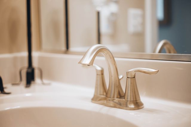 Stainless steel faucet over a white ceramic sink