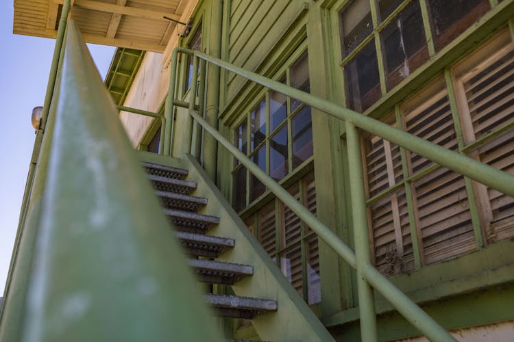 Green Metal Staircase Beside A Building