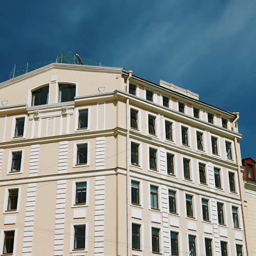 White and Beige Concrete Building Under Blue Sky