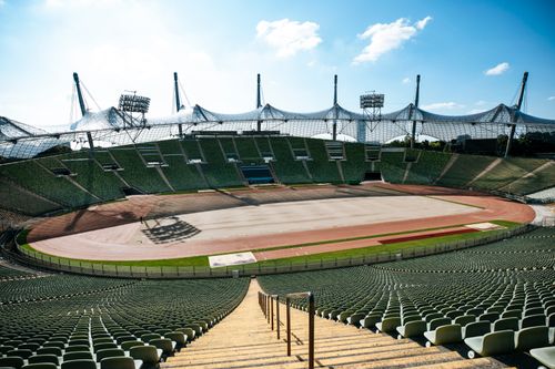 Free Wide-angle view of an empty football stadium with modern architecture under a clear sky. Stock Photo