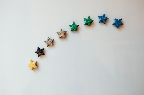 Colorful Sparkly Stars on a White Surface 