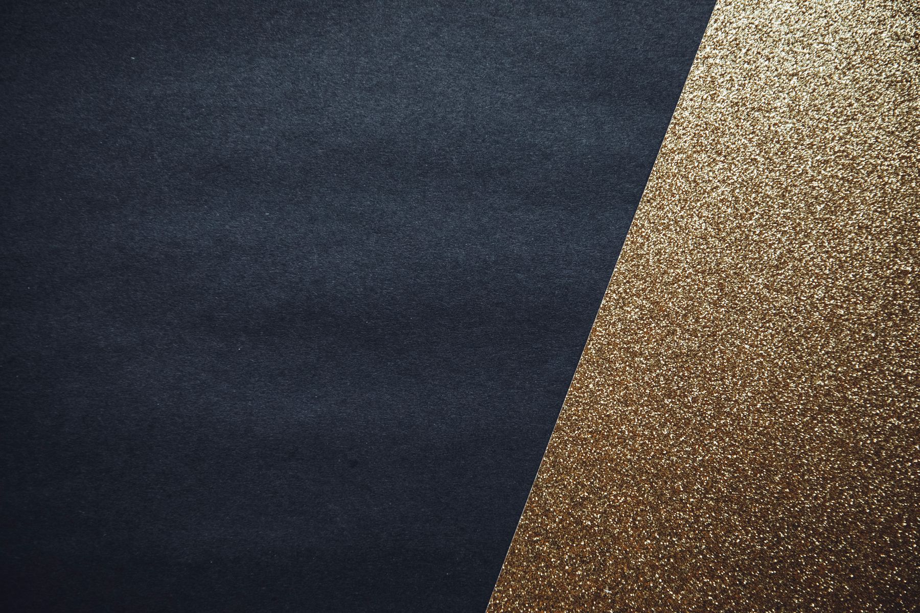 Deep navy paper meeting a field of fine gold