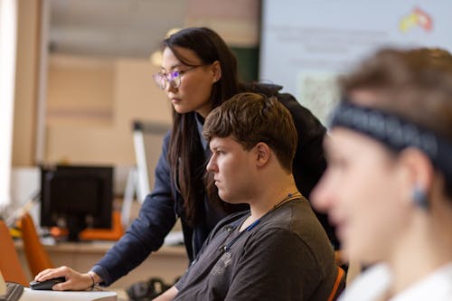 Free A Woman Teaching a Young Man  Stock Photo