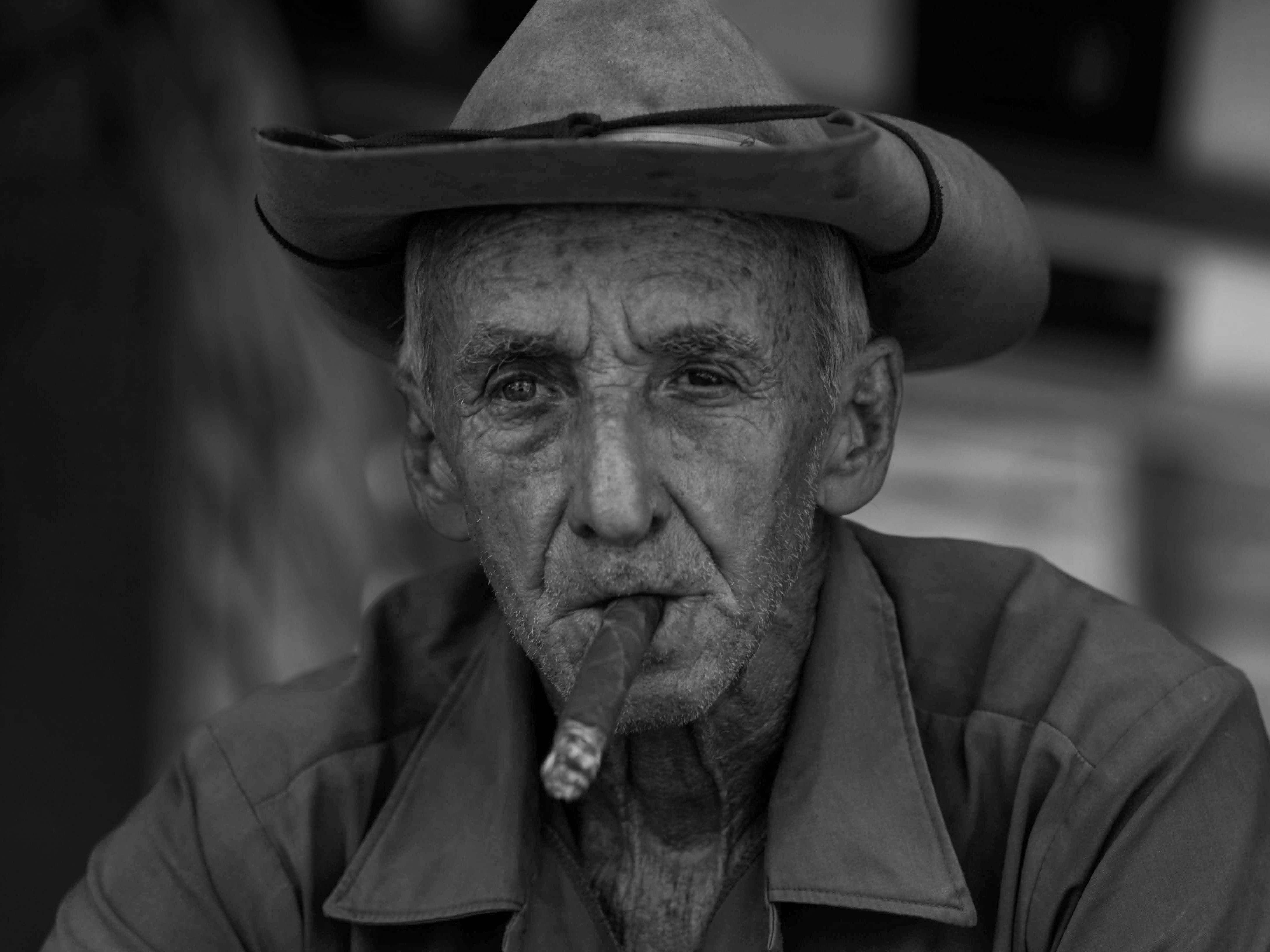 Grayscale Photo of an Elderly Man Wearing Cowboy Hat · Free Stock Photo
