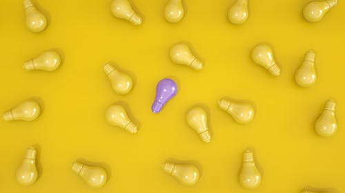 Flat Lay Photography of Light Bulbs on Yellow Surface