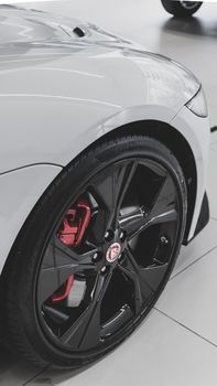 A high-quality close-up view of a sleek car wheel with a shiny rim and tire.
