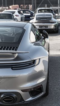 A group of luxury sports cars parked outdoors, showcasing sleek modern designs.