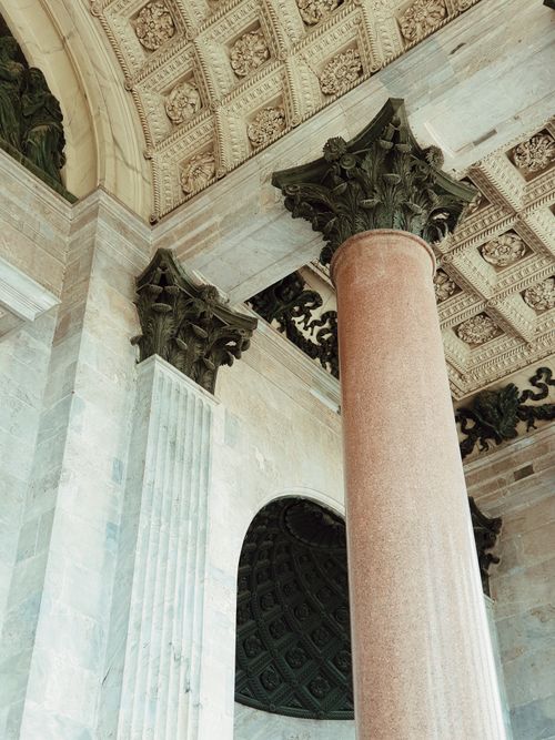 Free A low angle view of ornate columns and intricate ceiling details showcasing classic architecture. Stock Photo