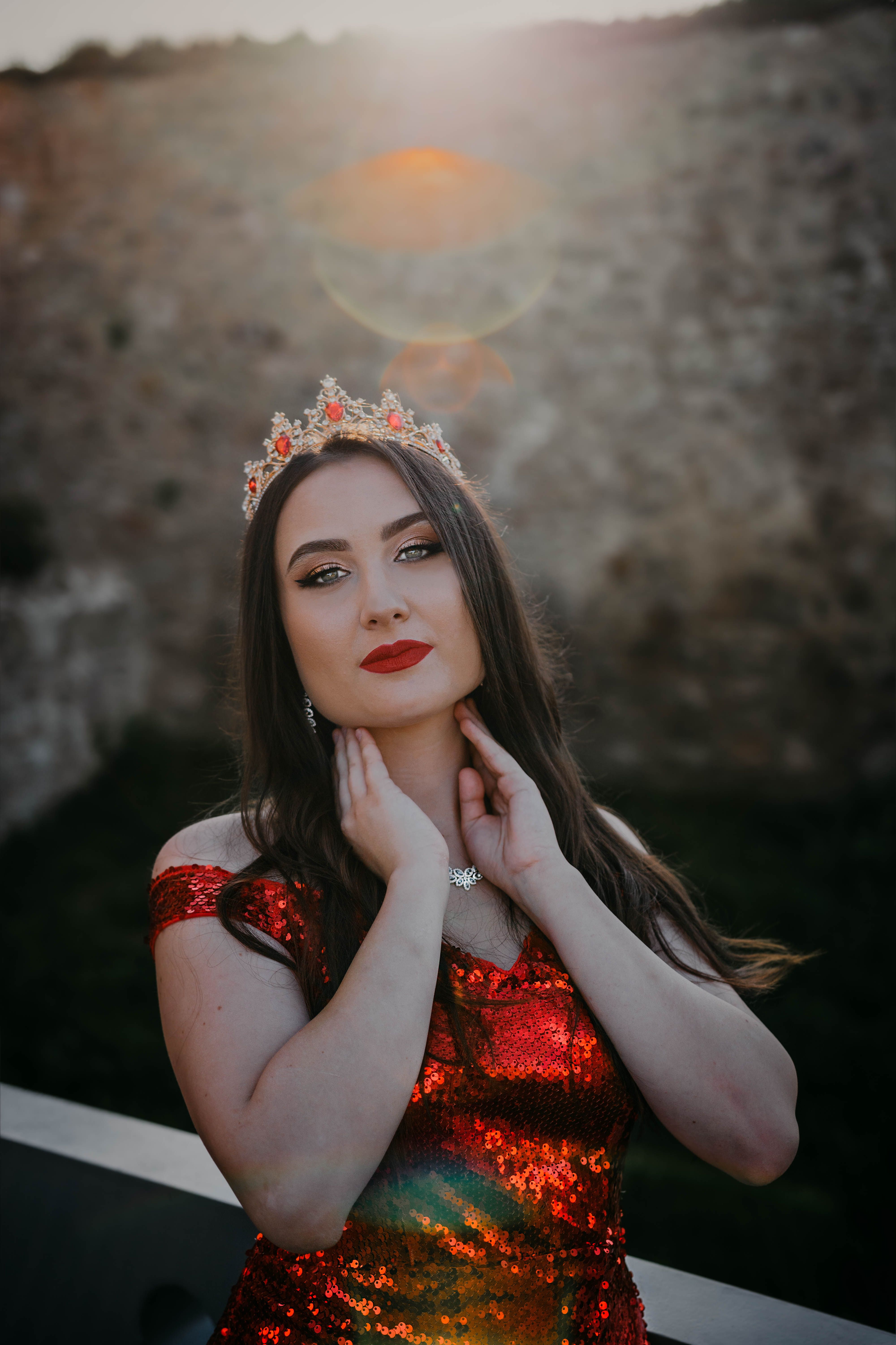 Elegant Woman in Red Sparkling Dress and a Crown · Free Stock Photo