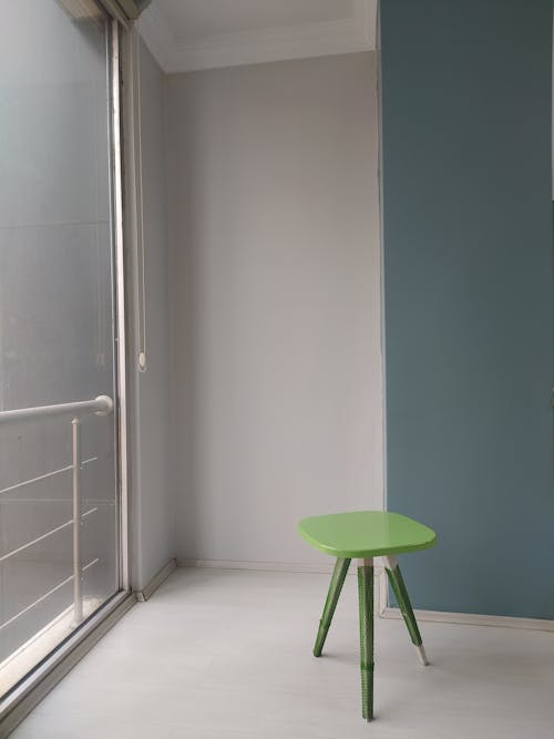 Green Stool near a Wall 