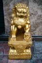 Gold Lion Statue on Blue and Red Textile