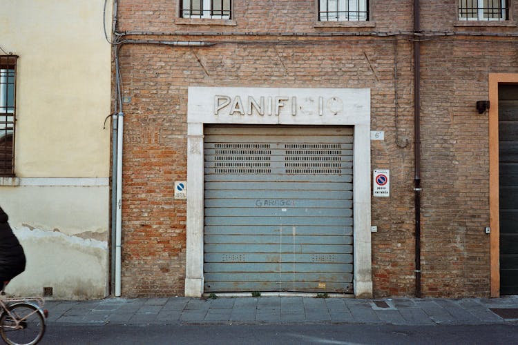 Closed Garage Doors In Abandoned Brick Building