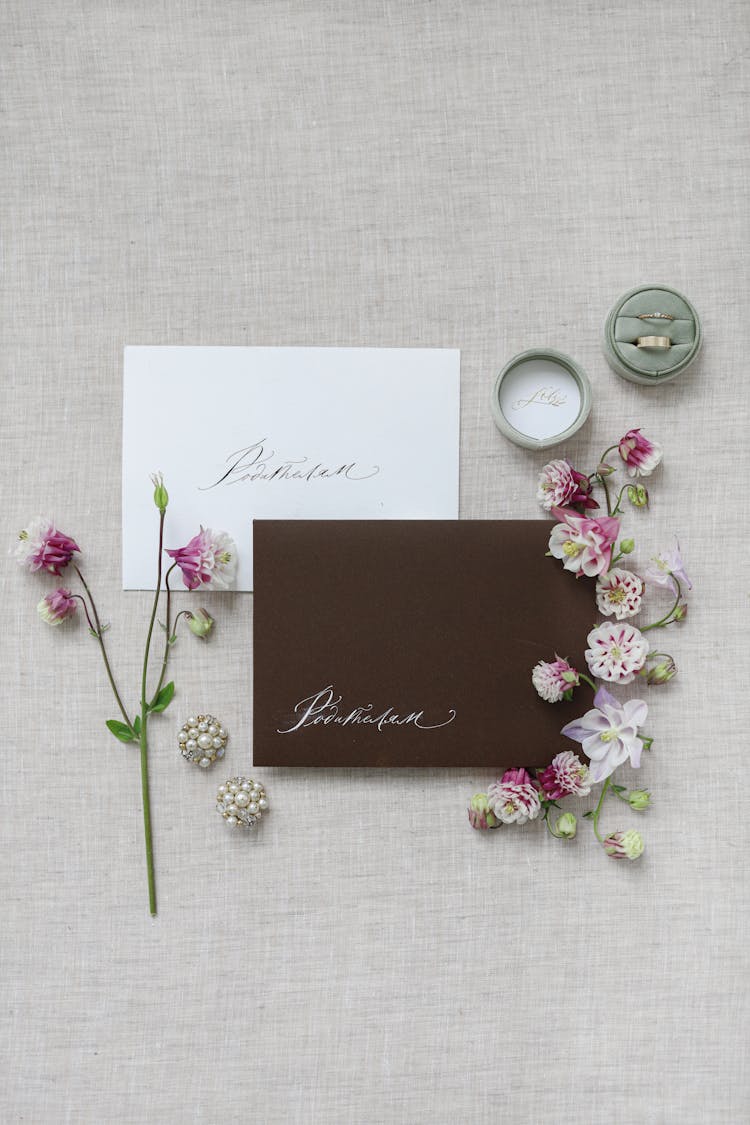 Wedding Invitation Cards Beside Flowers