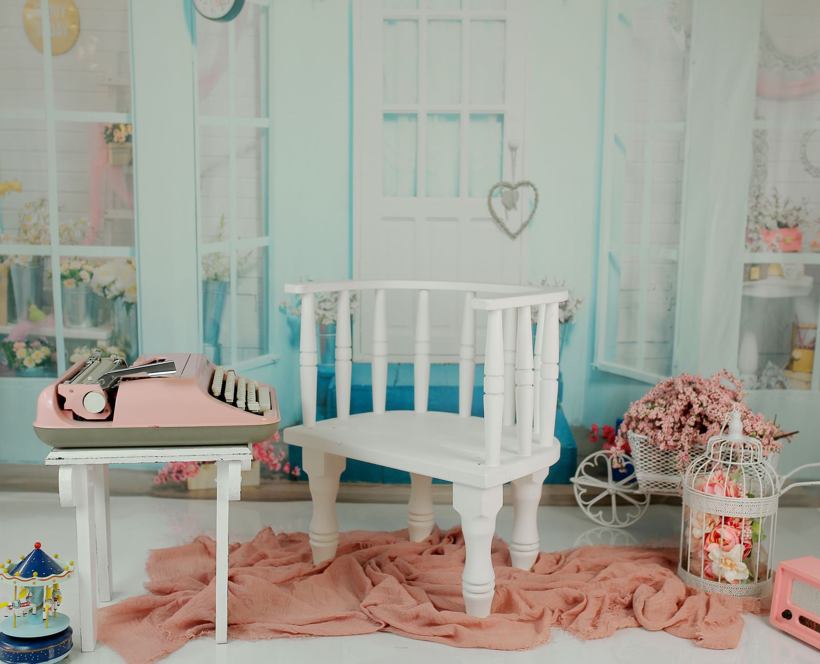A charming pastel-themed interior featuring a vintage typewriter and decor elements.