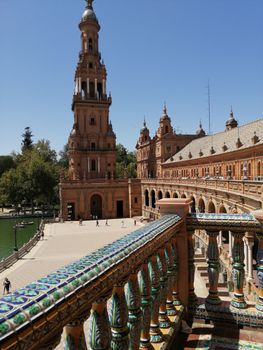 View of the iconic Plaza de España's architecture in Seville, Spain, featuring ornate ceramic details.