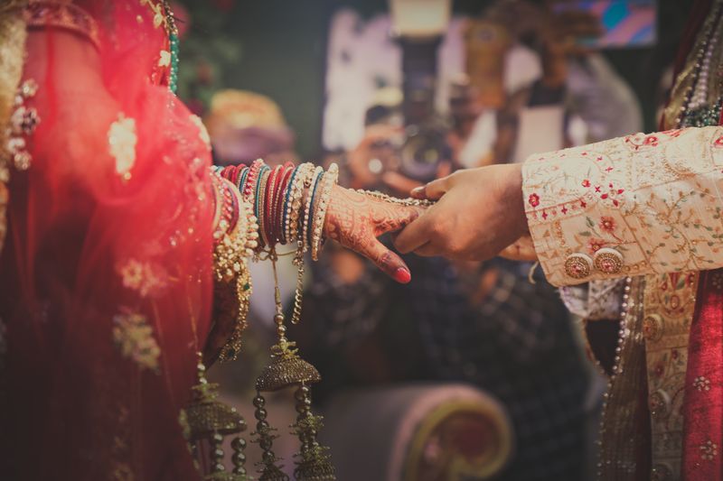 Bride and groom holding hands during the ceremony