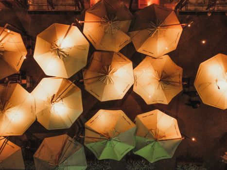 Stunning aerial shot of illuminated umbrellas at dusk in a Brazilian outdoor setting.