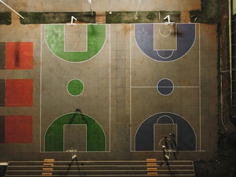 Top-down view of vibrant basketball courts at night in Brazil, showing detailed court markings.