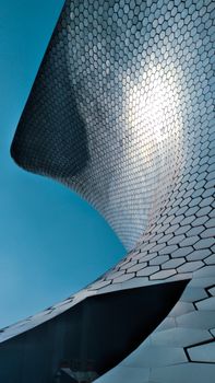 Stunning vertical shot of Museo Soumaya's unique architecture in Mexico City under clear sky.
