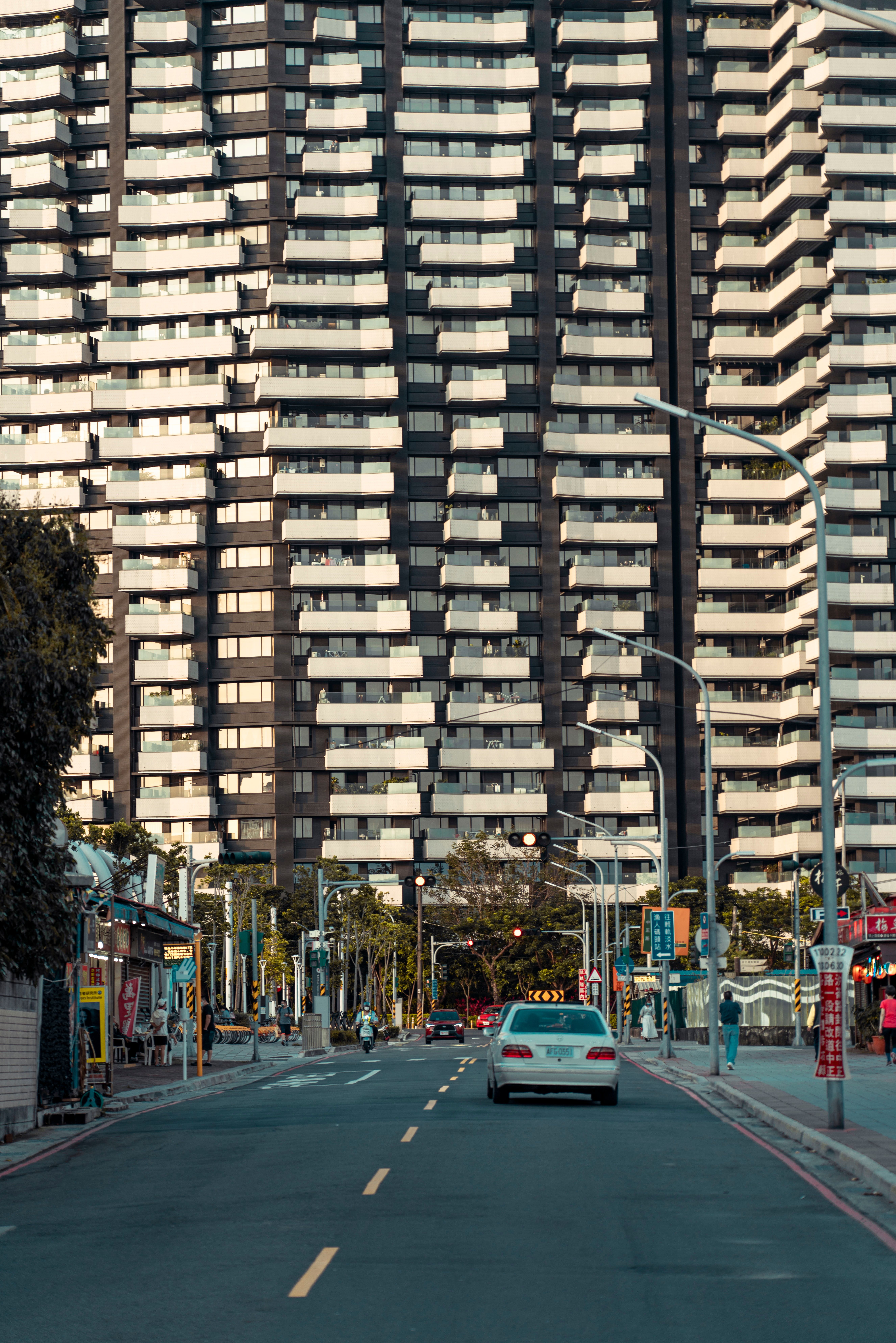 Cars on Road Near High Rise Building · Free Stock Photo