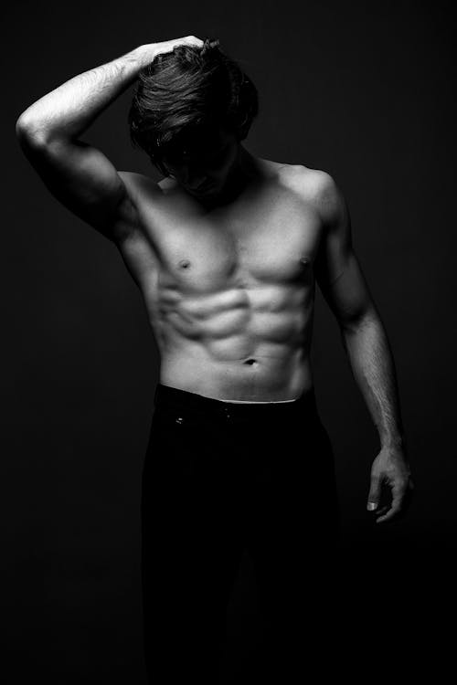 Free Shirtless Man with Muscular Build Posing  Stock Photo