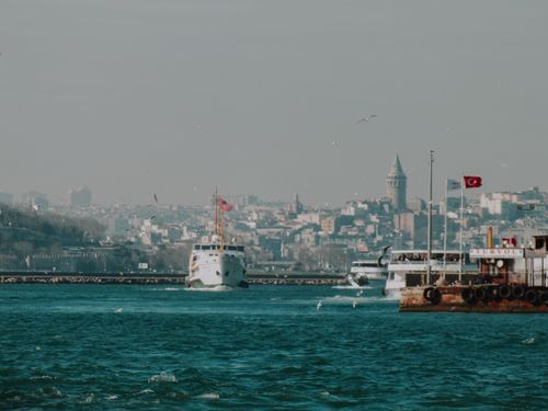 Free Picturesque scene of ships on the Bosphorus with Galata Tower in Istanbul, showcasing urban maritime life. Stock Photo