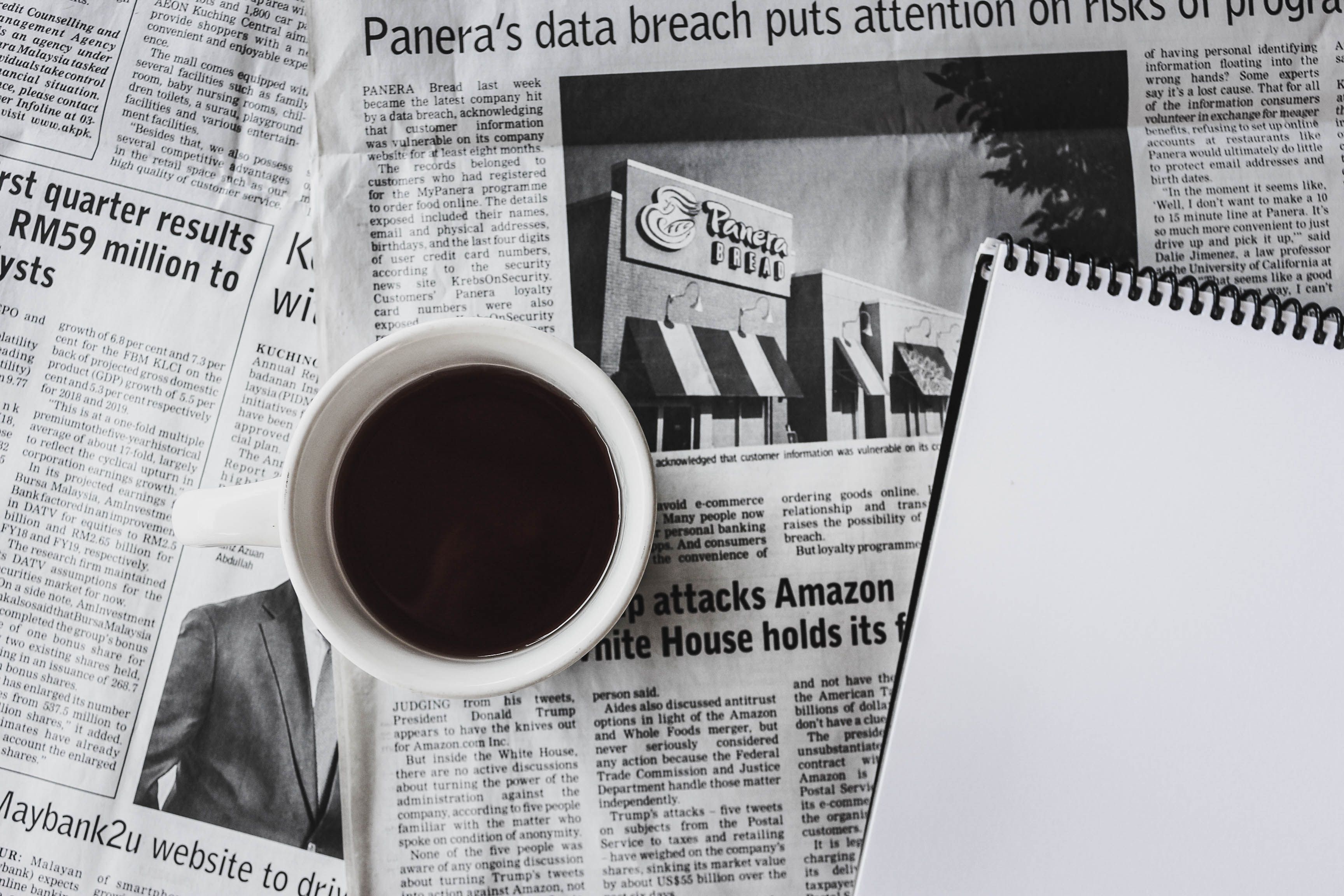 Newspaper and coffee on a table, ready for a morning crossword