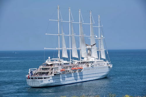 Cruise Ship with Sails Sailing under a Blue Sky