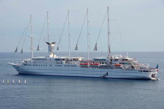 Elegant cruise ship with masts on a serene sea near France.