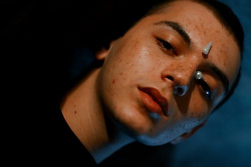 Free Creative close-up portrait with facial art, capturing a surreal and moody vibe. Stock Photo