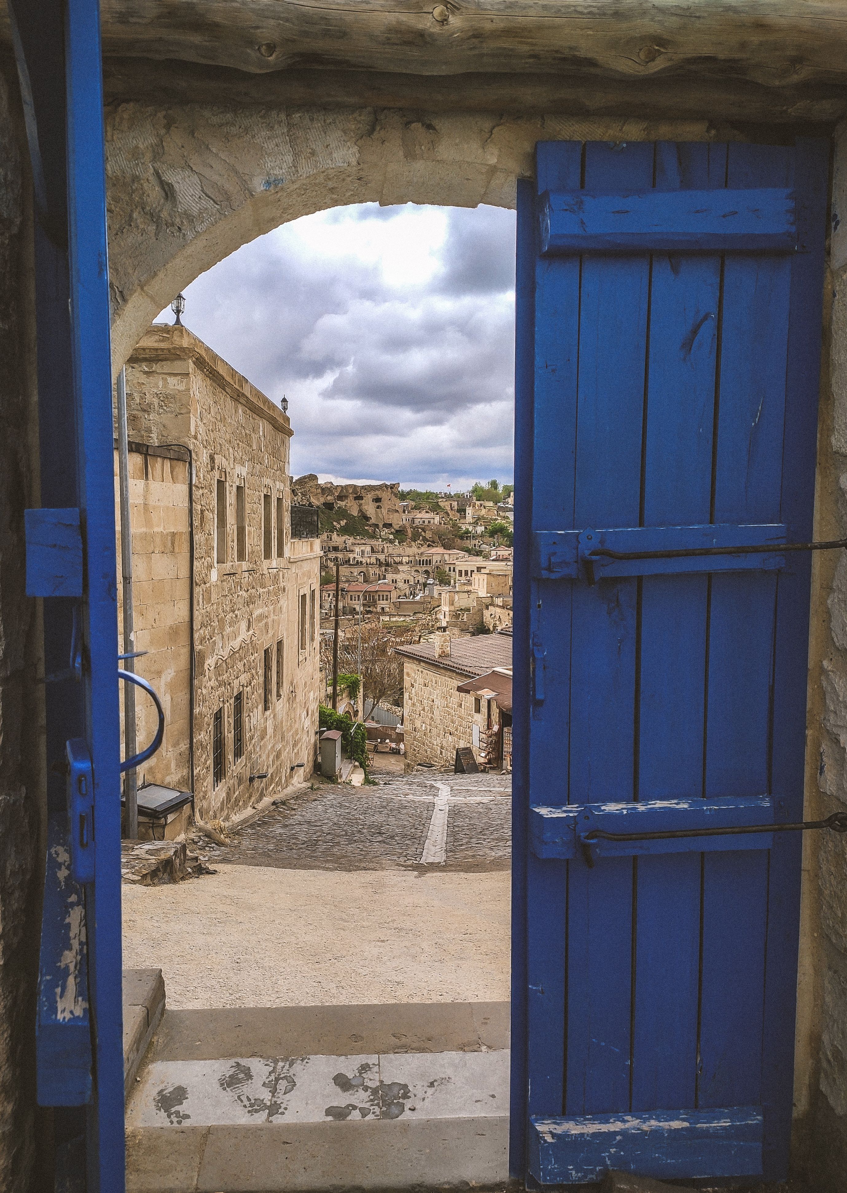 Blue Wooden Door Near Old Concrete Building · Free Stock Photo