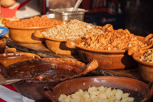 Traditional Mexican food served in rustic clay bowls, showcasing a variety of authentic dishes.