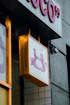 Charming hanging sign featuring a cat outline, adding character to the storefront. 12203620