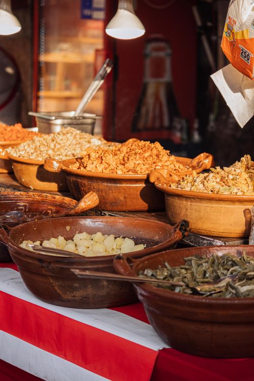 Free A colorful display of diverse traditional street food in pottery bowls, ready to be served. Stock Photo