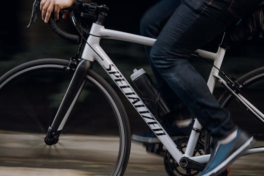 Dynamic shot of an adult riding a bicycle, showcasing movement and urban lifestyle.