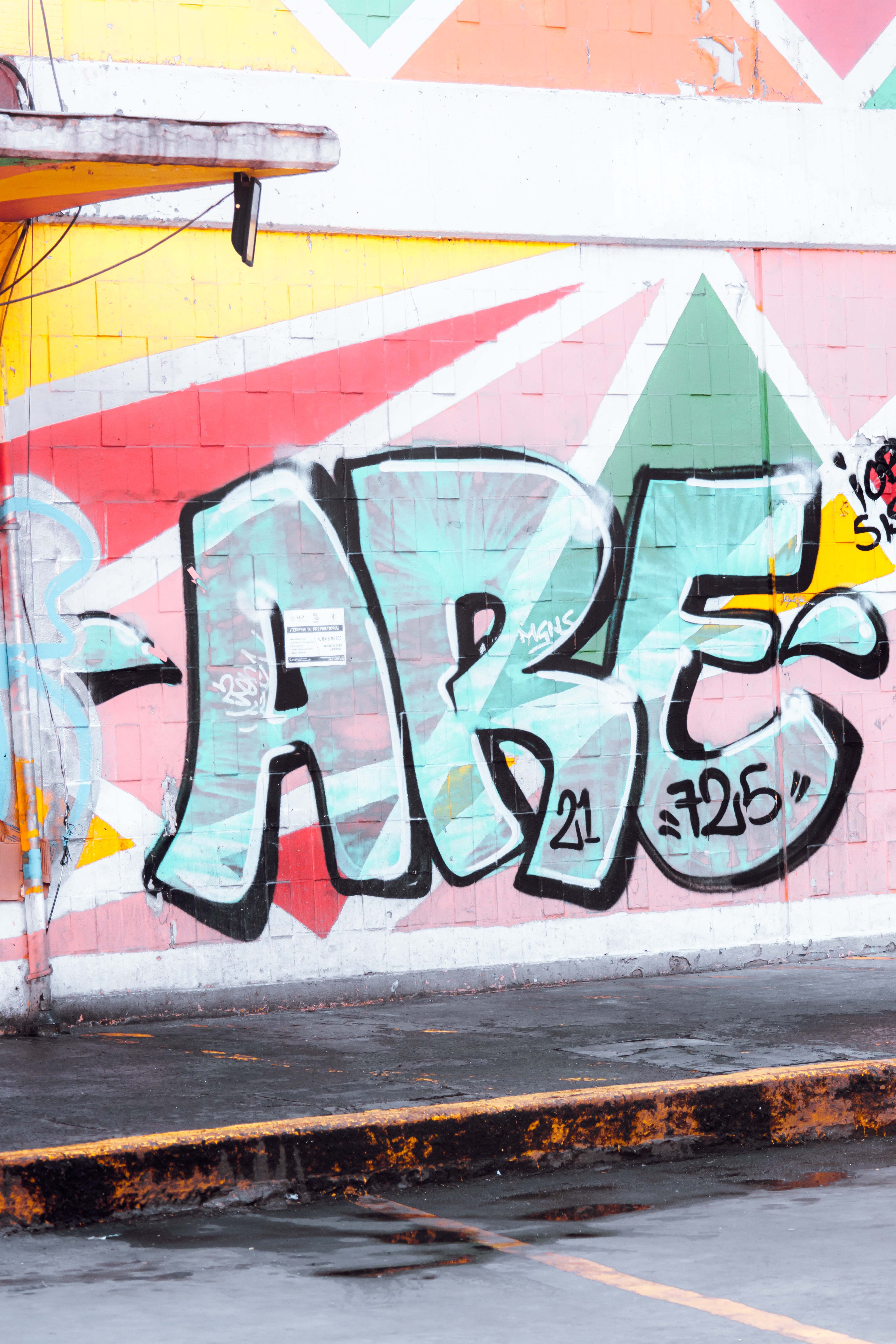 Bold graffiti art on a colorful city wall, showcasing street culture and creativity.