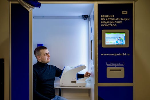Caucasian man smiling while using automated healthcare booth for blood pressure and health checks.
