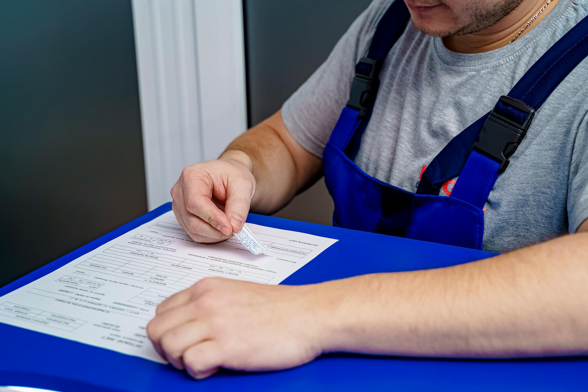 Man in Uniform Working with Paperwork