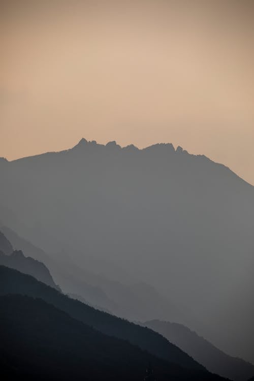 Silhouettes of Mountains on a Foggy Weather