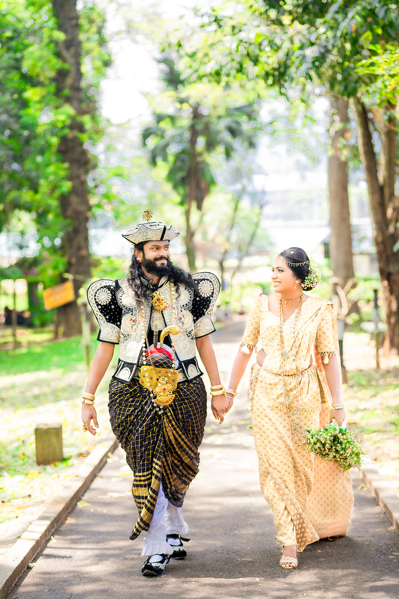 Sri Lankan couple in traditional attire walking hand in hand