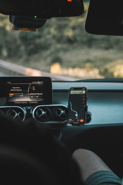 Free A car interior showing GPS navigation system and dashboard on a sunny day. Stock Photo