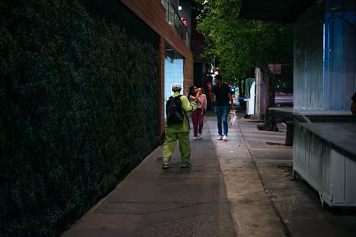 People Walking on the Sidewalk of the Street 
