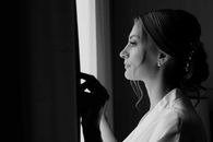 Black and White Photo of a Woman Looking Through the Window
