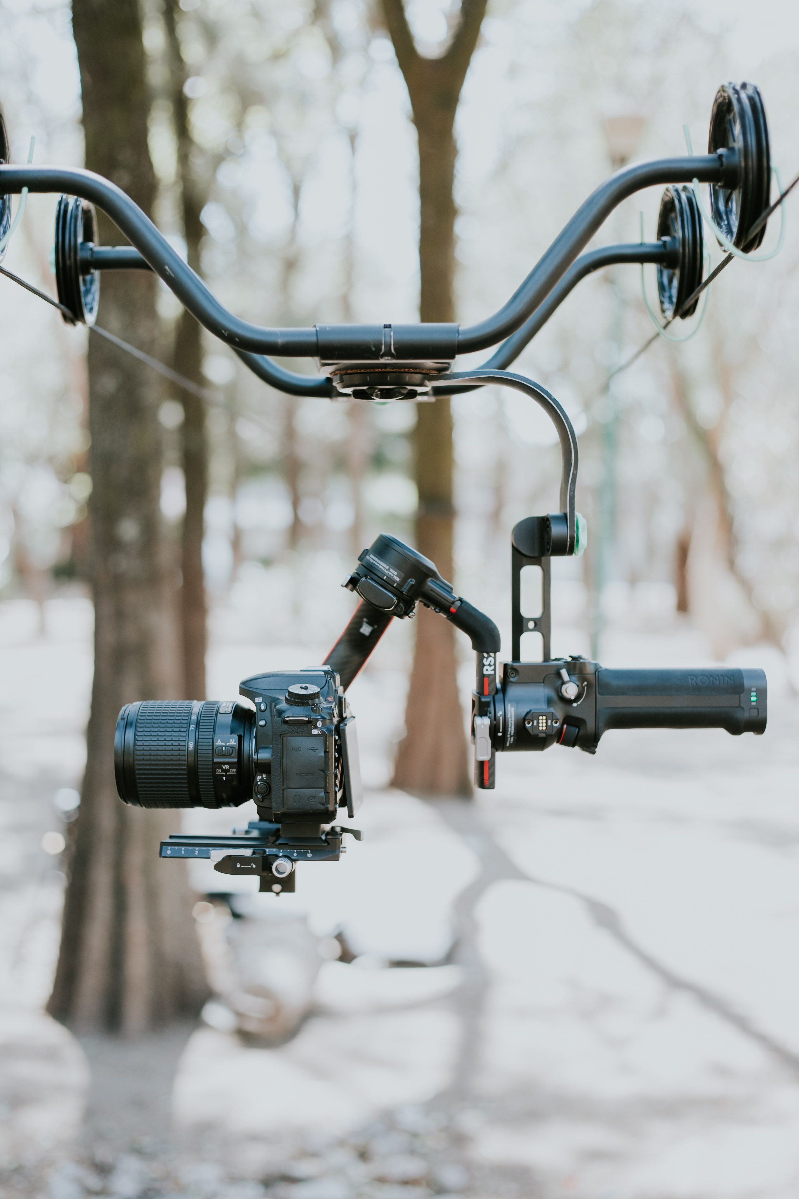 Close-up of a professional camera mounted on a gimbal, set up outdoors for stable filming.