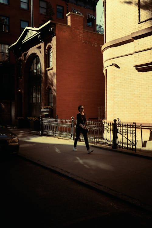 Woman Walking on a Sidewalk