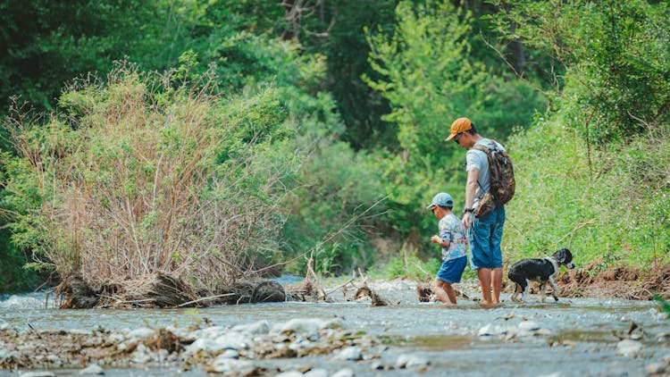 Father And Son Walking On A River 