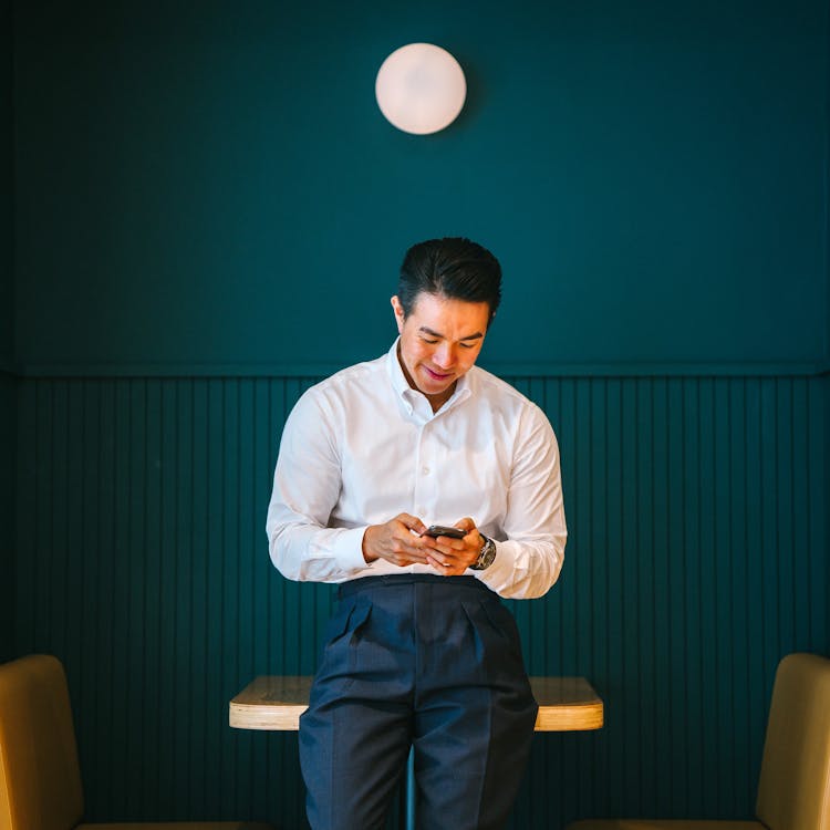 Man Holding Black Smartphone