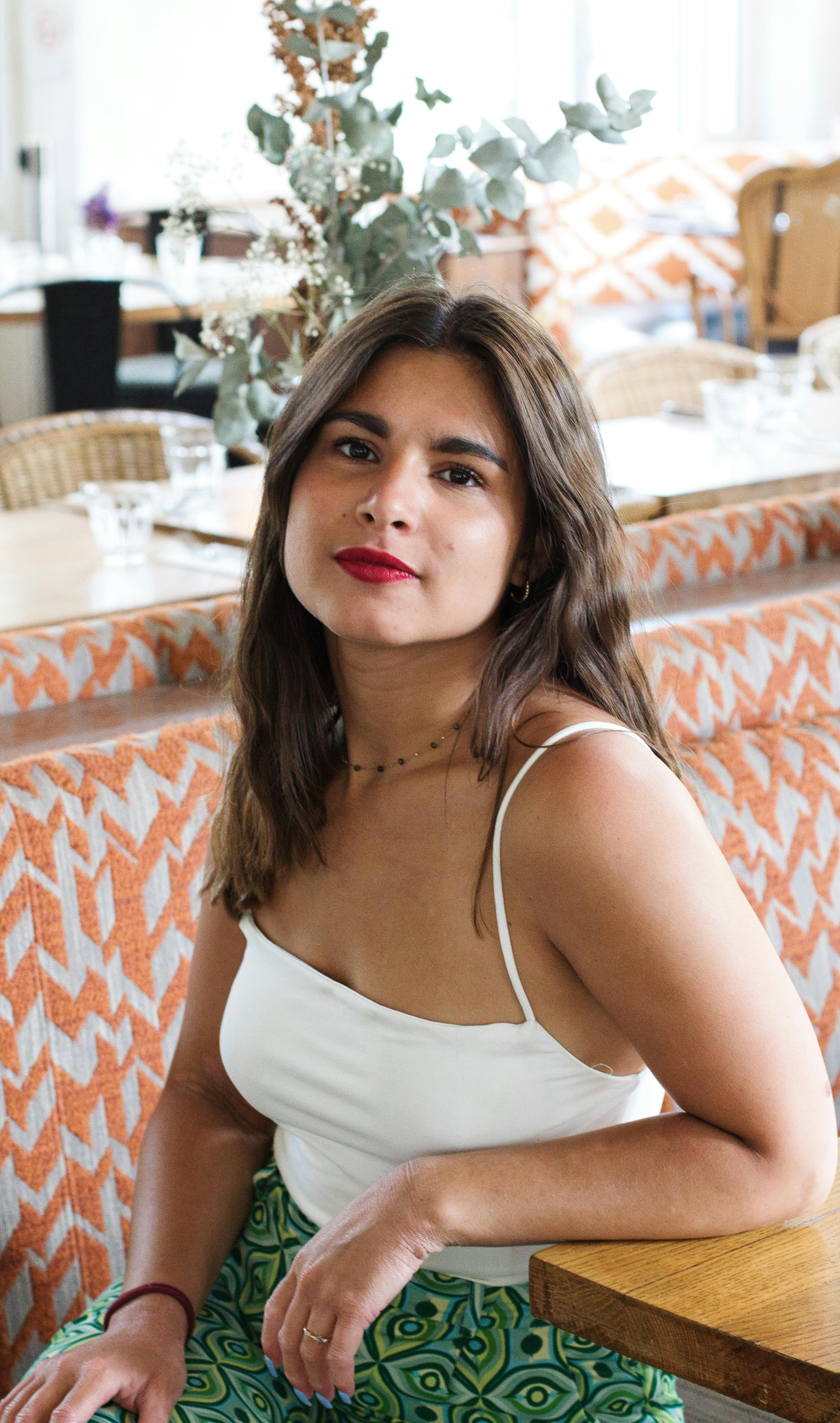 Portrait of a fashionable woman in a chic Paris cafe setting.
